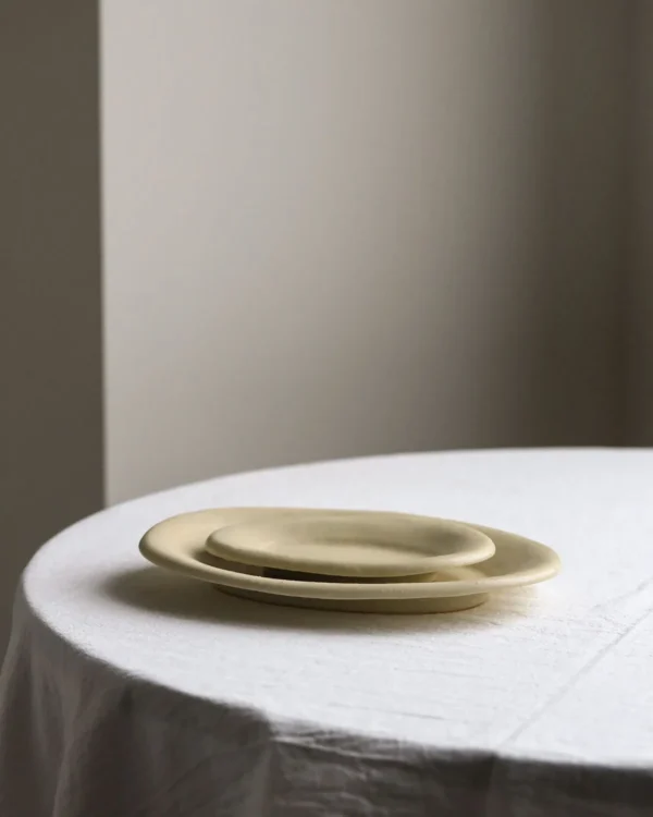 Artist Collaboration Oval Ceramic Plates in Pale Straw Glaze — in a room setting