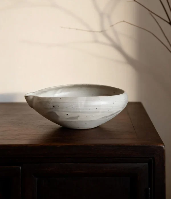Artist Collaboration Stoneware Spouted Large Bowl with Ears in ivory — in a room setting