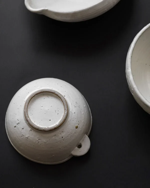 Artist Collaboration Stoneware Spouted Large Bowl with Ears in ivory — in a room setting
