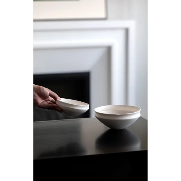 Artist Collaboration Folded-Edge Cone-Base Ceramic Bowls in ivory — in a room setting