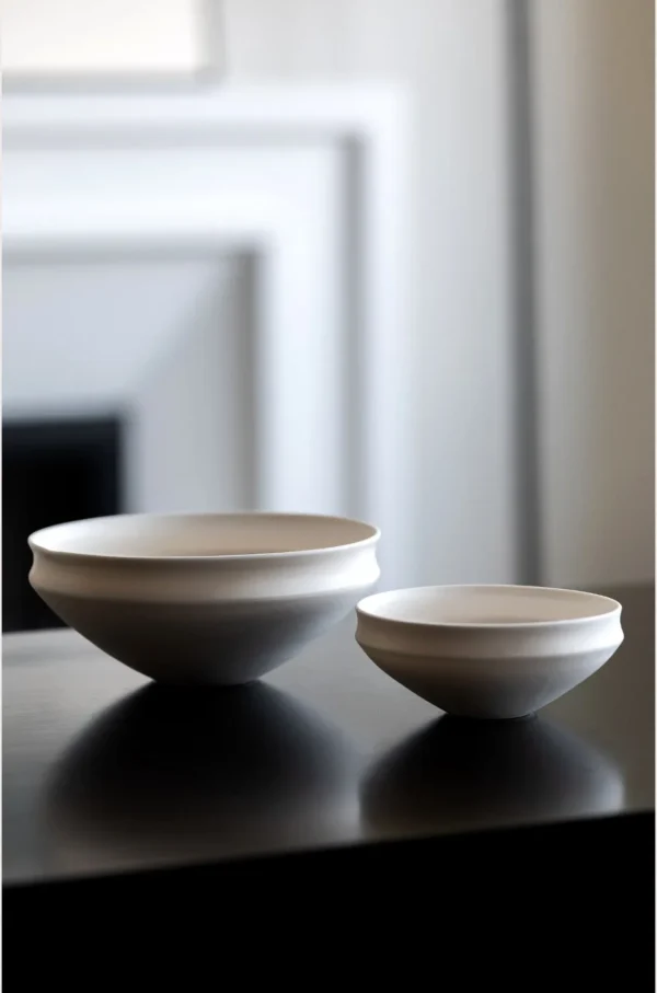 Artist Collaboration Folded-Edge Cone-Base Ceramic Bowls in ivory — in a room setting