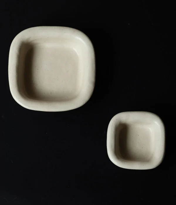 Artist Collaboration Folded-Edge Square Ceramic Dishes in oatmeal — in a room setting