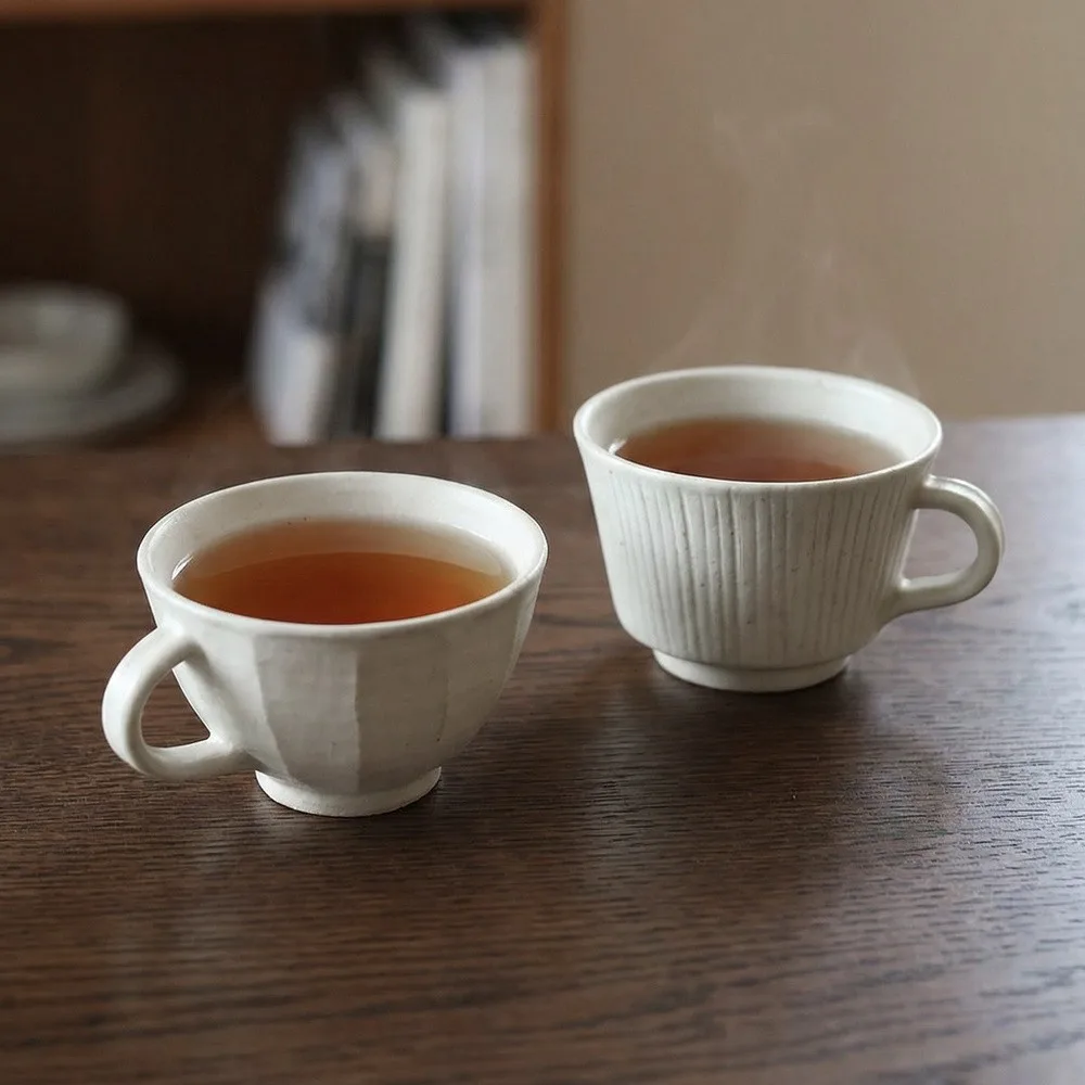 Artist Collaboration Hand-Made Ceramic Coffee Cups, Faceted in oatmeal — front view