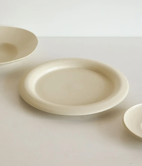 Artist Collaboration Off-White Ceramic Plates and Bowls Set in oatmeal — in a room setting