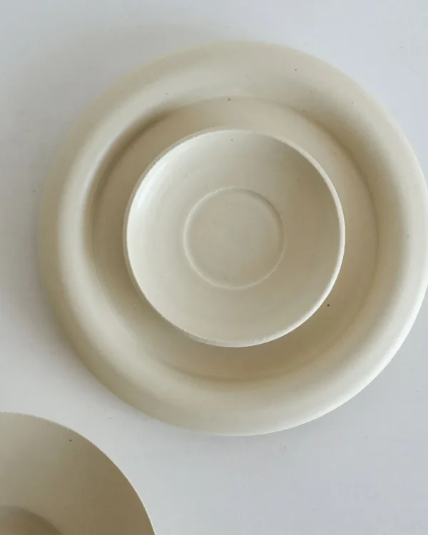 Artist Collaboration Off-White Ceramic Plates and Bowls Set in oatmeal — in a room setting