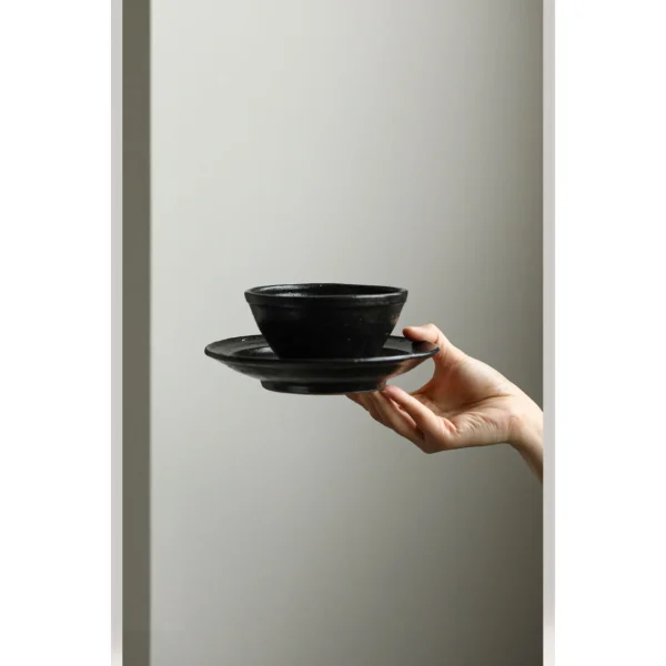 Artist Collaboration Stoneware Conical Rice Bowl and in black — in a room setting
