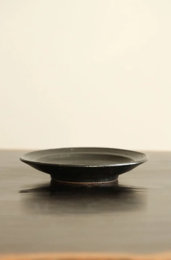 Artist Collaboration Stoneware Conical Rice Bowl and in black — in a room setting