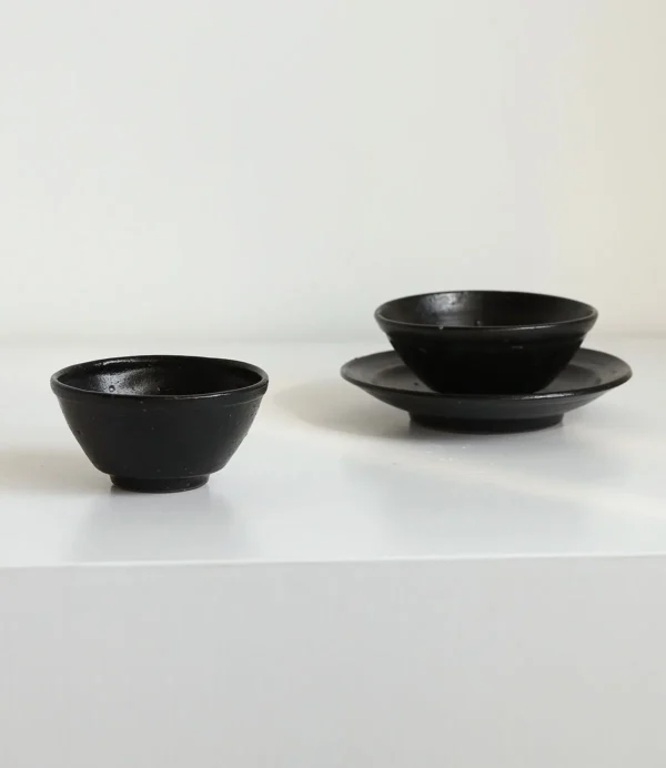 Artist Collaboration Stoneware Conical Rice Bowl and in black — in a room setting