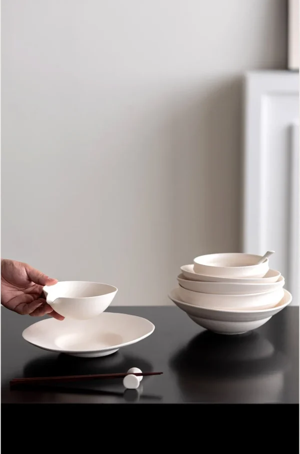 Artist Collaboration Cream Ceramic Pouring Bowl in oatmeal — in a room setting