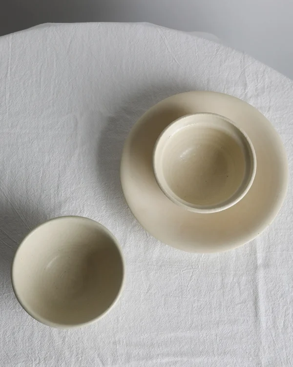 Artist Collaboration Rice-Glaze Plain Ceramic Bowl in oatmeal — in a room setting
