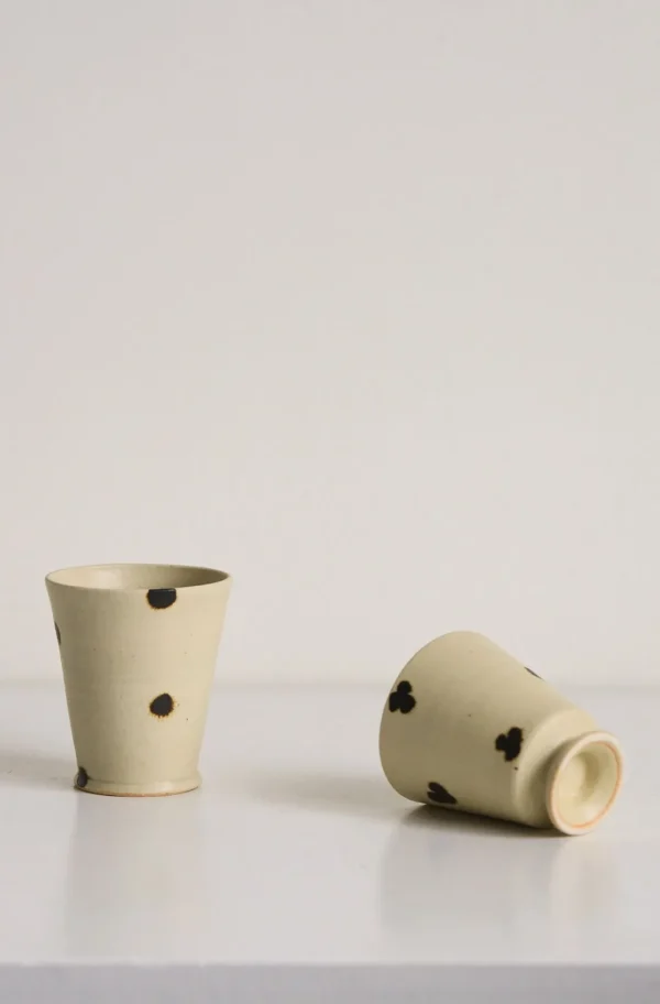 Artist Collaboration Dotted Stoneware Latte Cup, Cream in oatmeal — in a room setting