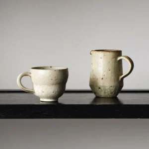 Artist Collaboration Stoneware Coffee Mug and Jug in olive — front view