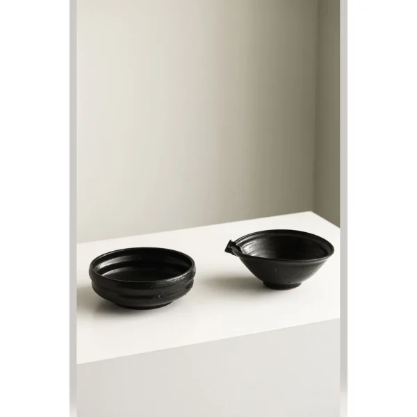 Artist Collaboration Black Glaze Stoneware Spouted Bowls in black — in a room setting