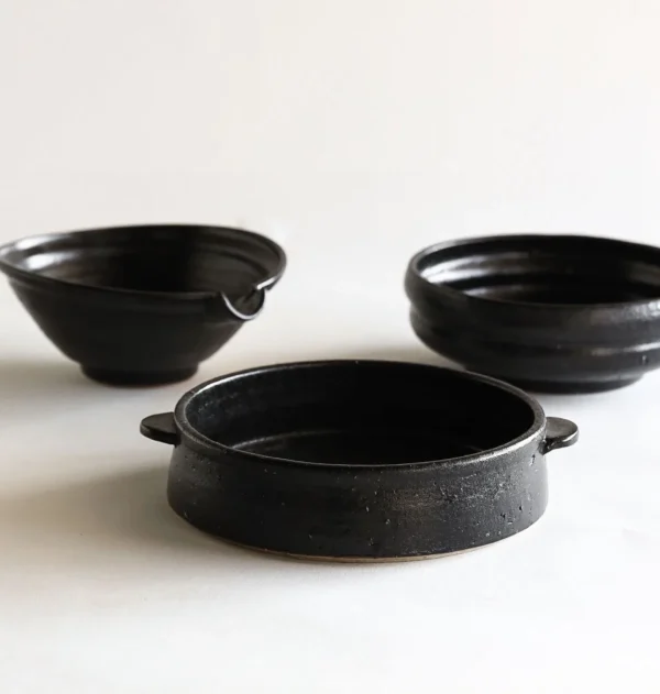 Artist Collaboration Black Glaze Stoneware Spouted Bowls in black — in a room setting