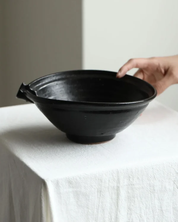 Artist Collaboration Black Glaze Stoneware Spouted Bowls in black — in a room setting