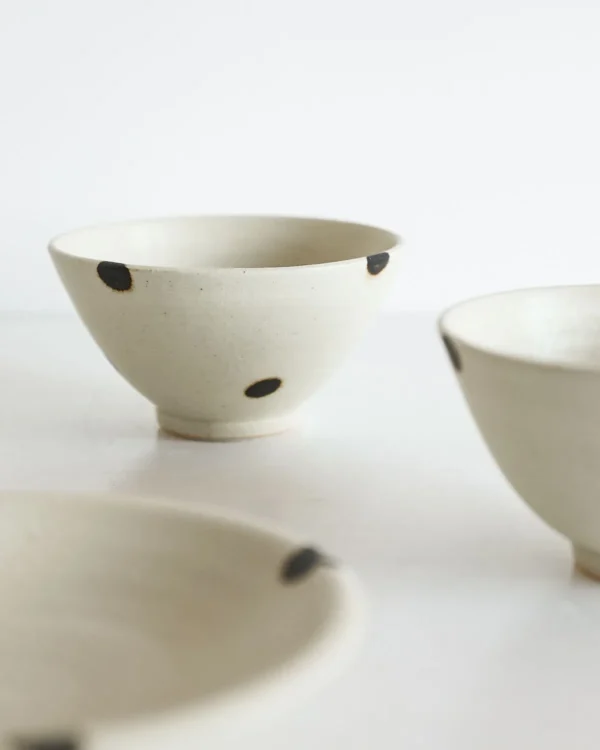 Artist Collaboration White Glaze Ink-Dot Ceramic Bowls and in ivory — in a room setting