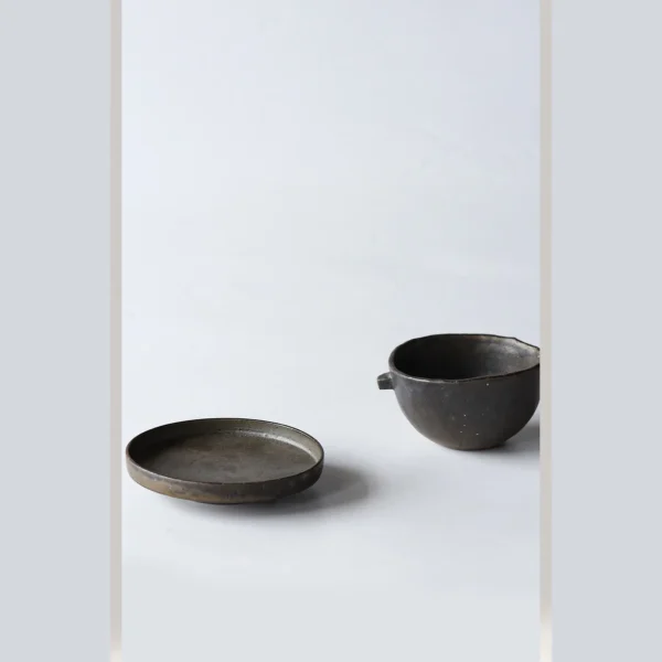 Artist Collaboration Dark Stoneware Eared Bowl and Plate in clay — in a room setting
