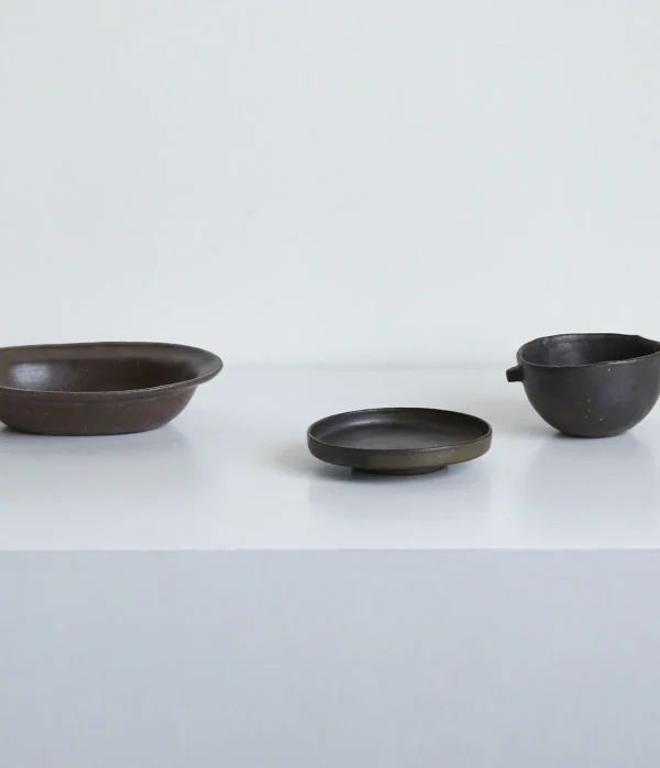 Artist Collaboration Dark Stoneware Eared Bowl and Plate in clay — in a room setting