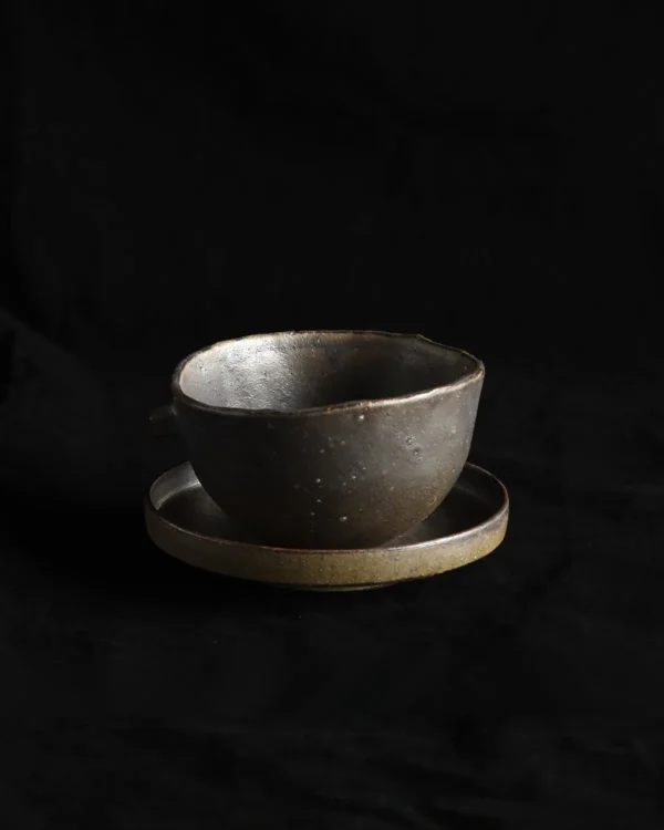 Artist Collaboration Dark Stoneware Eared Bowl and Plate in clay — in a room setting