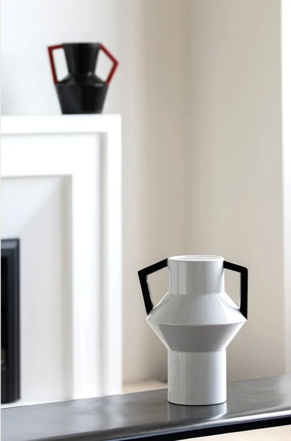Angular Black Ceramic Vase with Red Square Handles in black — in a room setting