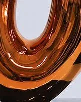 Amber Glass Loop Sculpture on Black Base, 30 x 43.5 cm in rust — detail