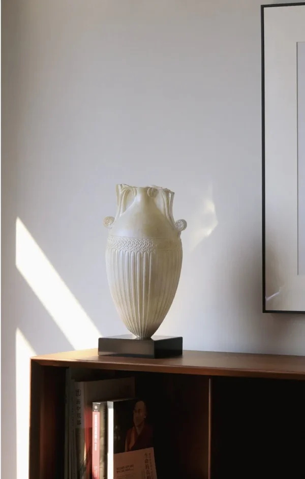 Jade-Effect Fluted Amphora Vase on Black Base in ivory — in a room setting