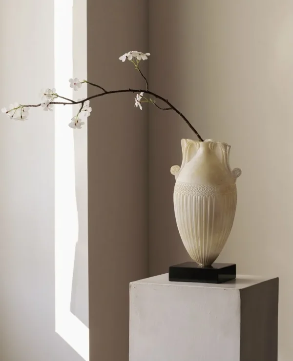 Jade-Effect Fluted Amphora Vase on Black Base in ivory — in a room setting