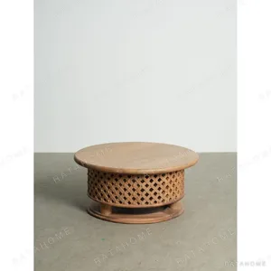 Round Teak Coffee Table with Lattice Drum Base, 110 cm in natural oak — in a room setting