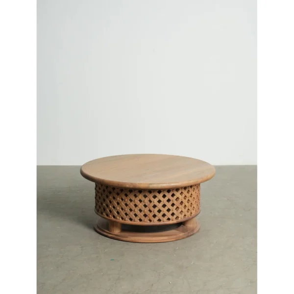 Round Teak Coffee Table with Lattice Drum Base, 110 cm in natural oak — in a room setting