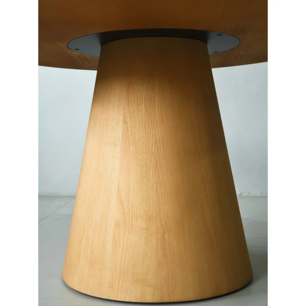 Solid Ash Round Dining Table on Cone Base in natural oak — in a room setting