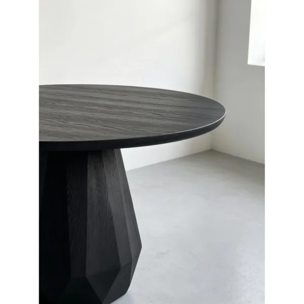 Matte Black Ash Round Table on Faceted Gem Base in black — in a room setting