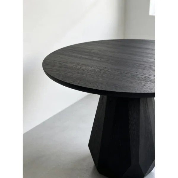 Matte Black Ash Round Table on Faceted Gem Base in black — in a room setting