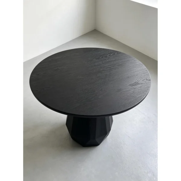 Matte Black Ash Round Table on Faceted Gem Base in black — in a room setting