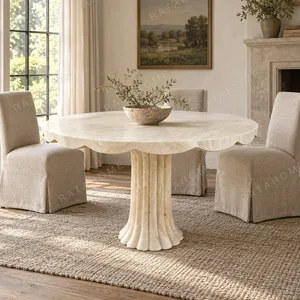 Scalloped Travertine Pedestal Table with Fluted Base in oatmeal — in a room setting
