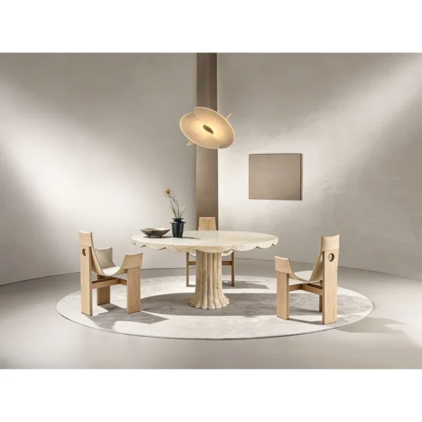 Scalloped Travertine Pedestal Table with Fluted Base in oatmeal — in a room setting