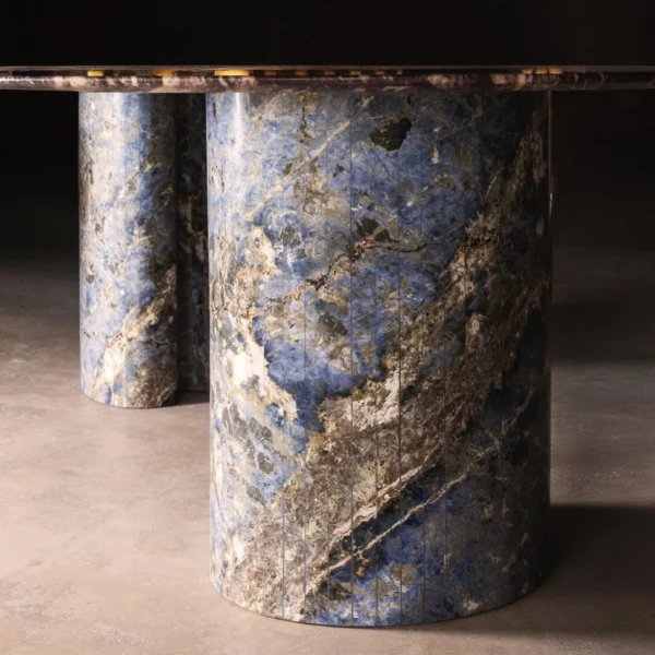 Lan Irregular Luxury Stone Dining Table with Blue Inlay in plum — in a room setting