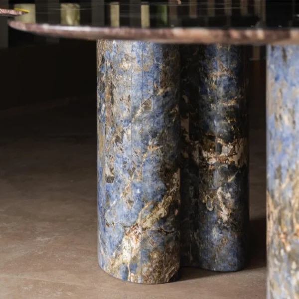 Lan Irregular Luxury Stone Dining Table with Blue Inlay in plum — in a room setting