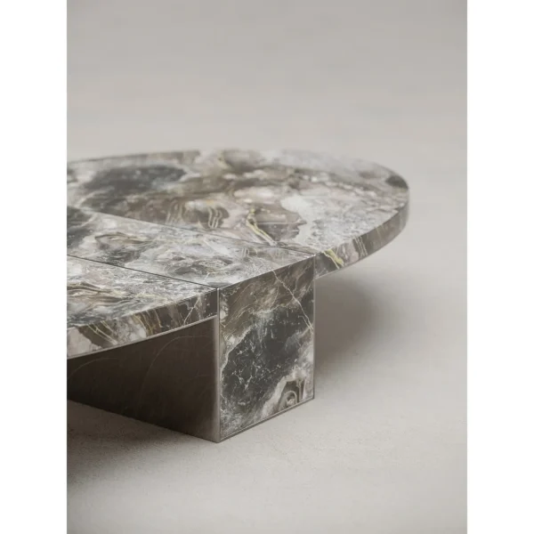 Minimalist Grey Marble Round Coffee Table on Triangular Base in slate — in a room setting