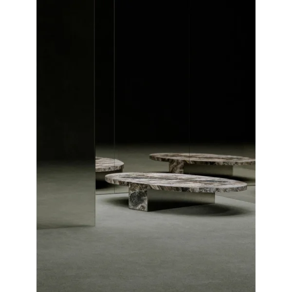 Minimalist Grey Marble Round Coffee Table on Triangular Base in slate — in a room setting