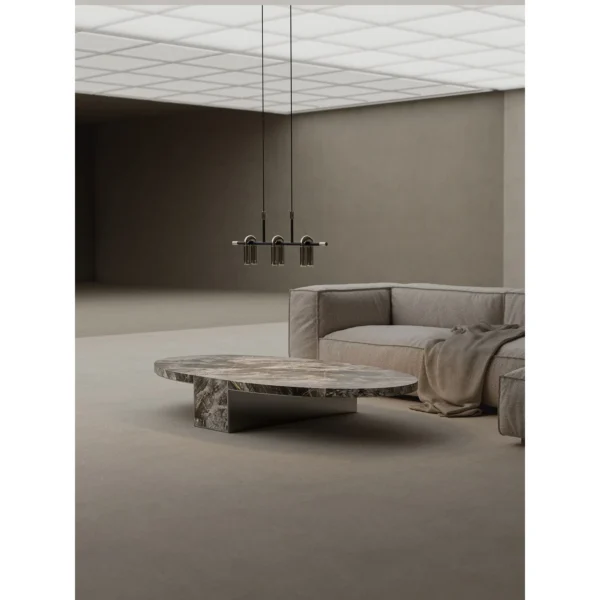 Minimalist Grey Marble Round Coffee Table on Triangular Base in slate — in a room setting
