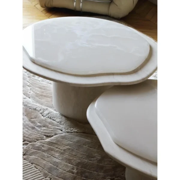 Super White Travertine Nesting Coffee Tables with Lobed Tops in ivory — in a room setting