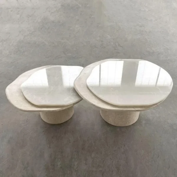 Super White Travertine Nesting Coffee Tables with Lobed Tops in ivory — in a room setting