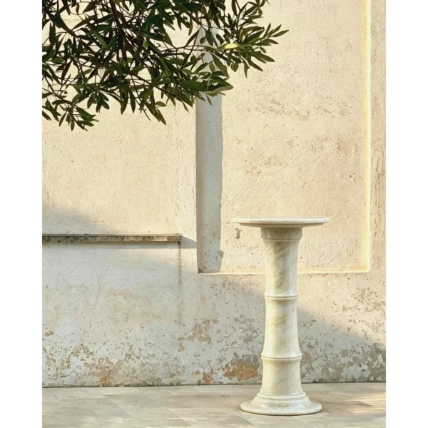 Xubaisheng Cloud Sequence Stone Pedestal Table in ivory — in a room setting