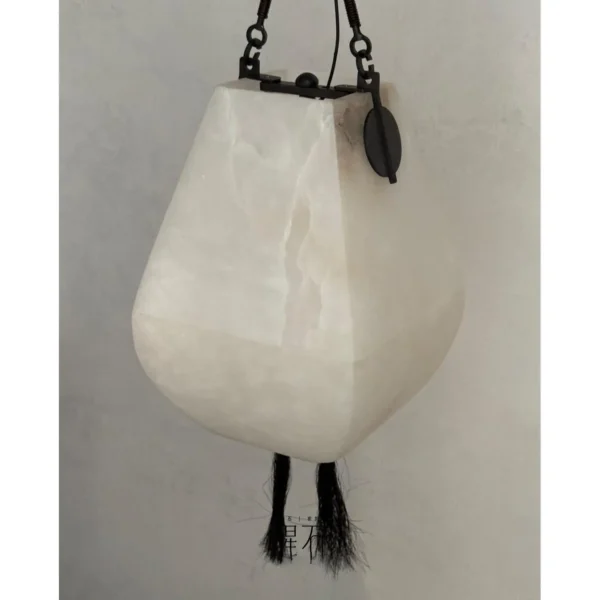 Cloud Alabaster Pendant Lamp with Leather Straps and Tassel in ivory — in a room setting