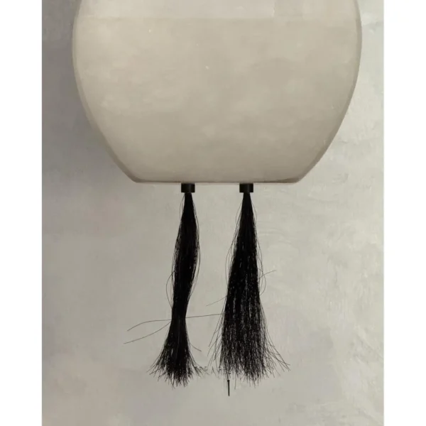 Cloud Alabaster Pendant Lamp with Leather Straps and Tassel in ivory — in a room setting