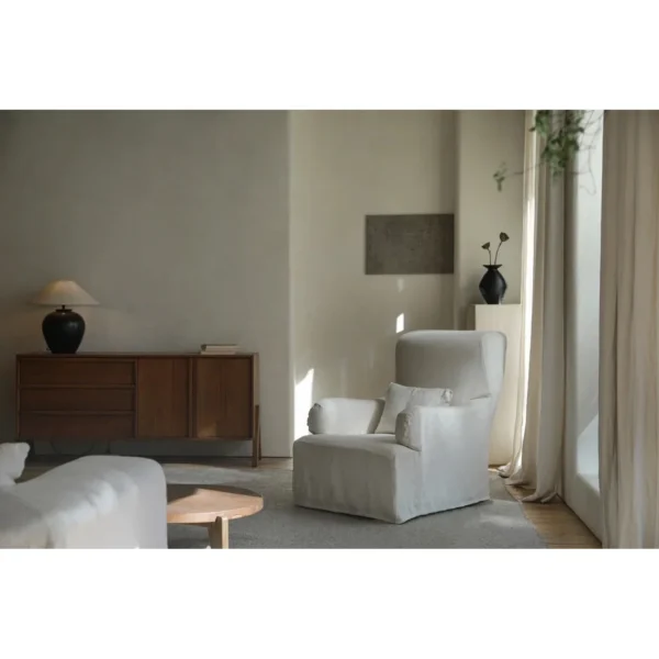 Slipcovered Linen Armchair with Ottoman in Off-White — in a room setting