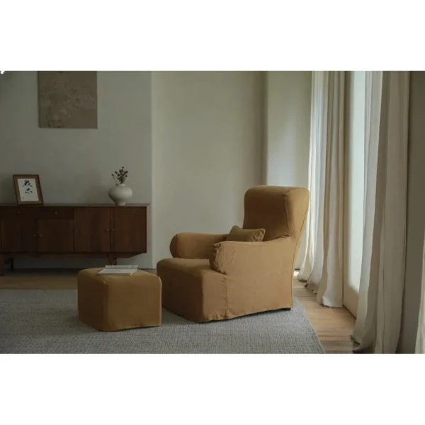 Slipcovered Linen Armchair with Ottoman in Off-White — in a room setting