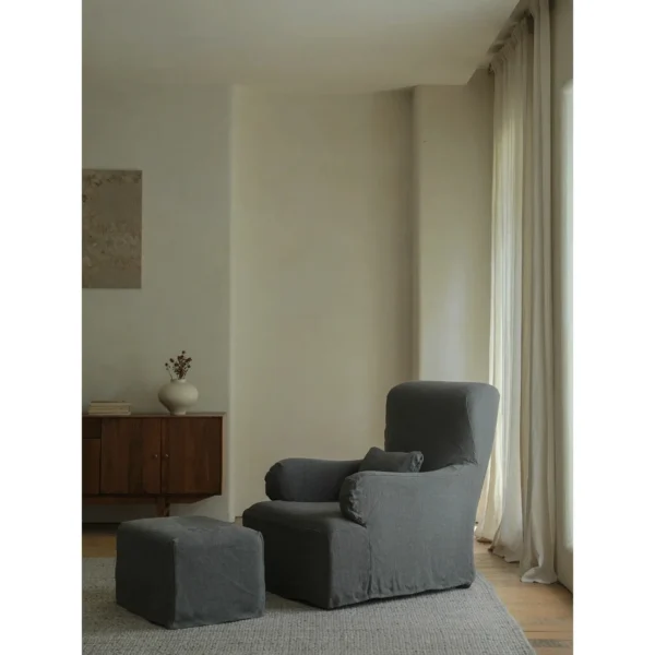 Slipcovered Linen Armchair with Ottoman in Off-White — in a room setting