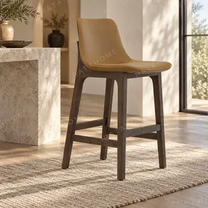 Tan Leather Bar Stool with Dark Oak Legs in clay — in a room setting