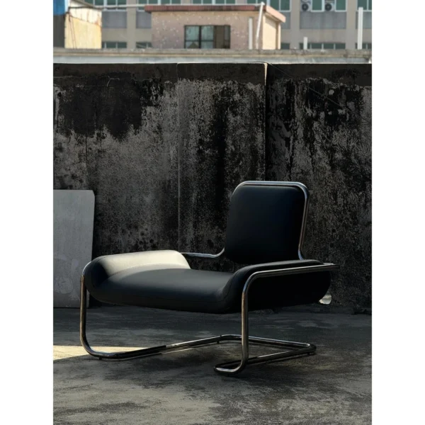 Bauhaus Black Leather Cantilever Lounge Chair on Steel Frame in black — in a room setting